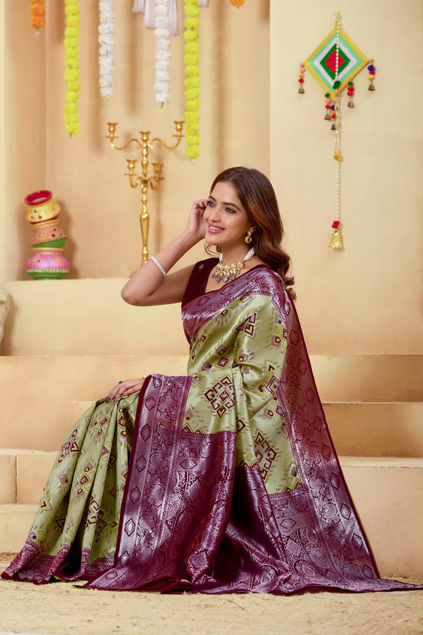 Woven Design Zari Patola Saree Woven Design Zari Patola Saree + Add elegance to your ethnic collection with this stunning green, chiku maroon and burgundy patola saree, inspired by rich heritage and modern style. This beautiful drape reflects shades like lime green saree, pista green saree, mint, pastel, and parrot green saree, blended with deeper tones of bottle green saree, leaf green saree, grass green saree, emerald, and gold green saree. The overall look gives a luxurious Golden Lime zari finish, perfect for festive wear. Designed with a premium woven design saree with zari border, this saree showcases the artistry of traditional patola saree weaving. The intricate detailing and subtle buti pattern enhance its beauty, giving it the richness of a classic banarasi saree and elegant handloom saree. This patola silk saree is ideal for saree traditional styling and modern designer saree for wedding looks.