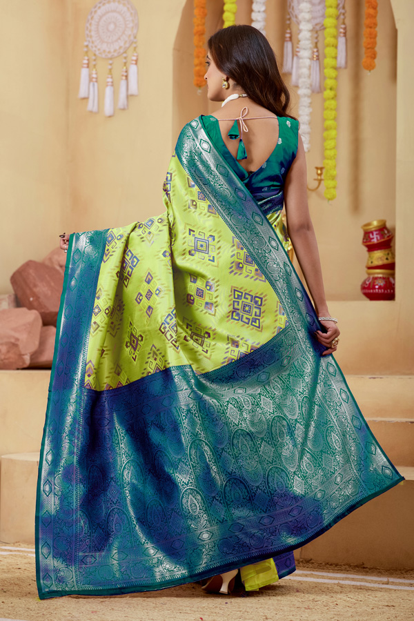 Woven Design Zari Patola Saree Geometric Woven Design Zari Patola Saree + Elevate your ethnic wardrobe with this stunning lime green saree featuring a unique geometric pattern saree design. The blend of lime green, teal green, and peacock green tones creates a refreshing and modern appeal, perfect for festive and traditional occasions. Crafted with intricate zari woven saree detailing, this saree showcases a rich contrast border saree style that enhances its elegance. The luxurious texture resembles pure saree silk, making it an ideal choice for those who love silk saree collections with a contemporary twist.