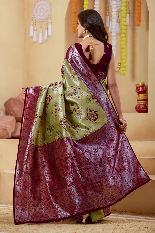 Woven Design Zari Patola Saree Woven Design Zari Patola Saree + Add elegance to your ethnic collection with this stunning green, chiku maroon and burgundy patola saree, inspired by rich heritage and modern style. This beautiful drape reflects shades like lime green saree, pista green saree, mint, pastel, and parrot green saree, blended with deeper tones of bottle green saree, leaf green saree, grass green saree, emerald, and gold green saree. The overall look gives a luxurious Golden Lime zari finish, perfect for festive wear. Designed with a premium woven design saree with zari border, this saree showcases the artistry of traditional patola saree weaving. The intricate detailing and subtle buti pattern enhance its beauty, giving it the richness of a classic banarasi saree and elegant handloom saree. This patola silk saree is ideal for saree traditional styling and modern designer saree for wedding looks.