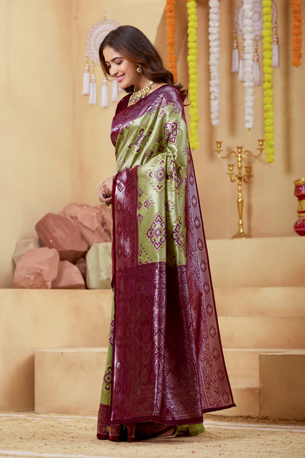 Woven Design Zari Patola Saree Woven Design Zari Patola Saree + Add elegance to your ethnic collection with this stunning green, chiku maroon and burgundy patola saree, inspired by rich heritage and modern style. This beautiful drape reflects shades like lime green saree, pista green saree, mint, pastel, and parrot green saree, blended with deeper tones of bottle green saree, leaf green saree, grass green saree, emerald, and gold green saree. The overall look gives a luxurious Golden Lime zari finish, perfect for festive wear. Designed with a premium woven design saree with zari border, this saree showcases the artistry of traditional patola saree weaving. The intricate detailing and subtle buti pattern enhance its beauty, giving it the richness of a classic banarasi saree and elegant handloom saree. This patola silk saree is ideal for saree traditional styling and modern designer saree for wedding looks.