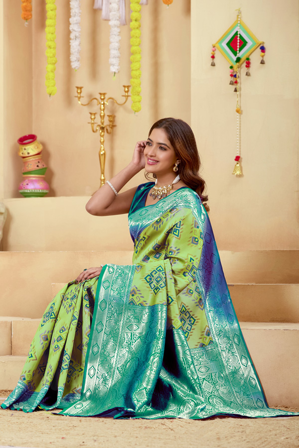 Woven Design Zari Patola Saree Geometric Woven Design Zari Patola Saree + Elevate your ethnic wardrobe with this stunning lime green saree featuring a unique geometric pattern saree design. The blend of lime green, teal green, and peacock green tones creates a refreshing and modern appeal, perfect for festive and traditional occasions. Crafted with intricate zari woven saree detailing, this saree showcases a rich contrast border saree style that enhances its elegance. The luxurious texture resembles pure saree silk, making it an ideal choice for those who love silk saree collections with a contemporary twist.