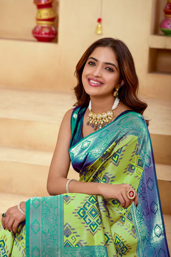 Woven Design Zari Patola Saree Geometric Woven Design Zari Patola Saree + Elevate your ethnic wardrobe with this stunning lime green saree featuring a unique geometric pattern saree design. The blend of lime green, teal green, and peacock green tones creates a refreshing and modern appeal, perfect for festive and traditional occasions. Crafted with intricate zari woven saree detailing, this saree showcases a rich contrast border saree style that enhances its elegance. The luxurious texture resembles pure saree silk, making it an ideal choice for those who love silk saree collections with a contemporary twist.