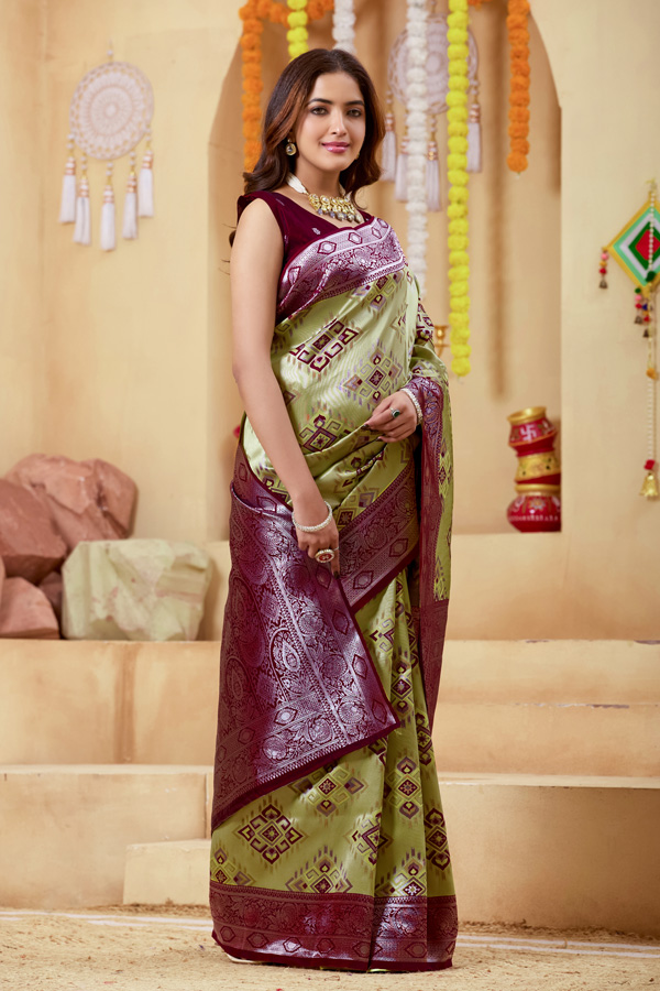 Woven Design Zari Patola Saree Woven Design Zari Patola Saree + Add elegance to your ethnic collection with this stunning green, chiku maroon and burgundy patola saree, inspired by rich heritage and modern style. This beautiful drape reflects shades like lime green saree, pista green saree, mint, pastel, and parrot green saree, blended with deeper tones of bottle green saree, leaf green saree, grass green saree, emerald, and gold green saree. The overall look gives a luxurious Golden Lime zari finish, perfect for festive wear. Designed with a premium woven design saree with zari border, this saree showcases the artistry of traditional patola saree weaving. The intricate detailing and subtle buti pattern enhance its beauty, giving it the richness of a classic banarasi saree and elegant handloom saree. This patola silk saree is ideal for saree traditional styling and modern designer saree for wedding looks.