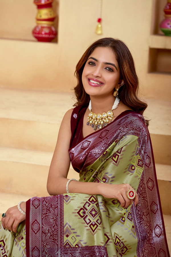 Woven Design Zari Patola Saree Woven Design Zari Patola Saree + Add elegance to your ethnic collection with this stunning green, chiku maroon and burgundy patola saree, inspired by rich heritage and modern style. This beautiful drape reflects shades like lime green saree, pista green saree, mint, pastel, and parrot green saree, blended with deeper tones of bottle green saree, leaf green saree, grass green saree, emerald, and gold green saree. The overall look gives a luxurious Golden Lime zari finish, perfect for festive wear. Designed with a premium woven design saree with zari border, this saree showcases the artistry of traditional patola saree weaving. The intricate detailing and subtle buti pattern enhance its beauty, giving it the richness of a classic banarasi saree and elegant handloom saree. This patola silk saree is ideal for saree traditional styling and modern designer saree for wedding looks.